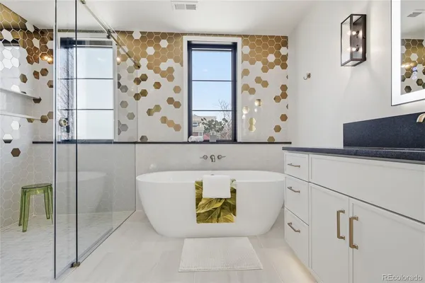 a bathroom with a bathtub and shower