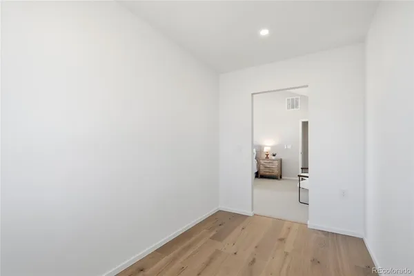a view of a room with wooden floor