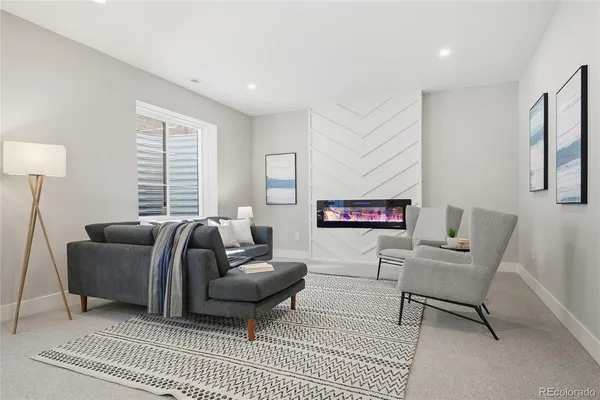 a living room with furniture and a rug