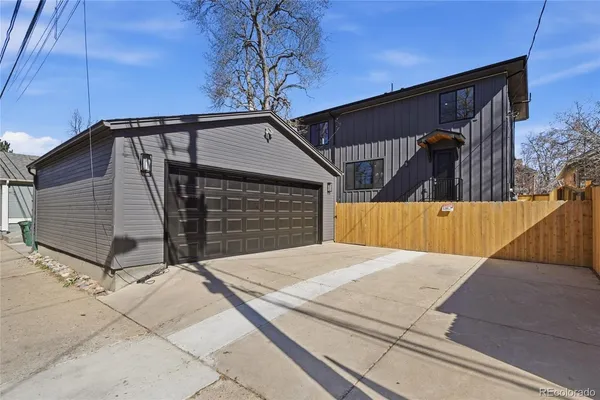 a view of backyard with small cabin and wooden fencing