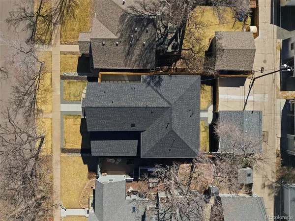 a aerial view of a house with large trees