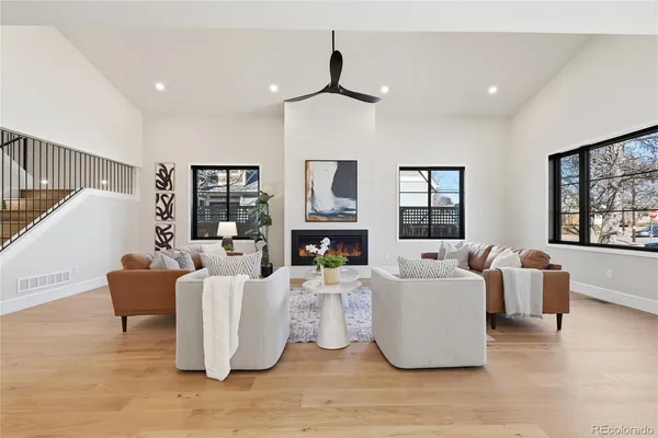 a living room with fireplace furniture and a wooden floor