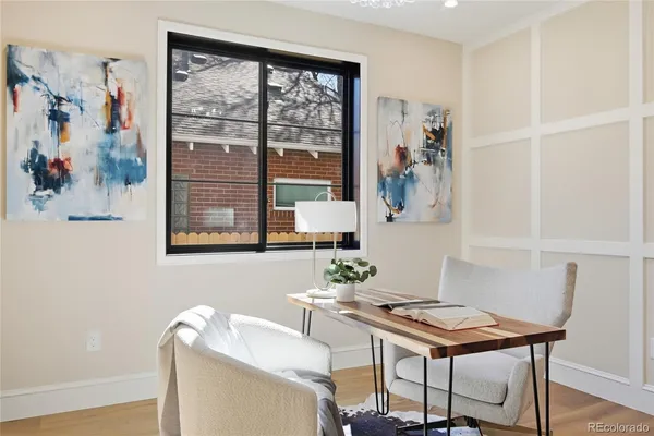 a view of a workspace with furniture and a window