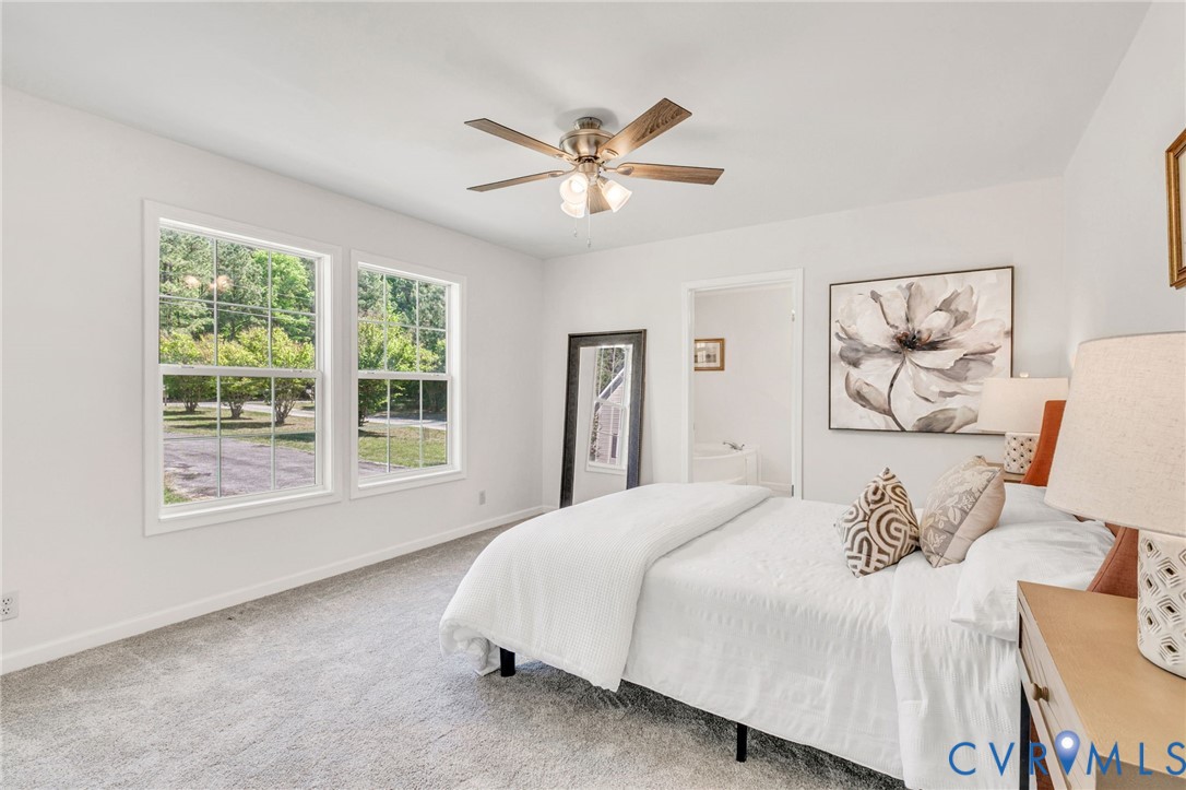 9424 Marlfield Road Gloucester, VA 23061 - Photo 18 of 31 a bedroom with a large bed and a window