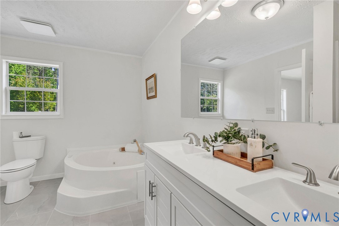 9424 Marlfield Road Gloucester, VA 23061 - Photo 20 of 31 a bathroom with a sink and a toilet
