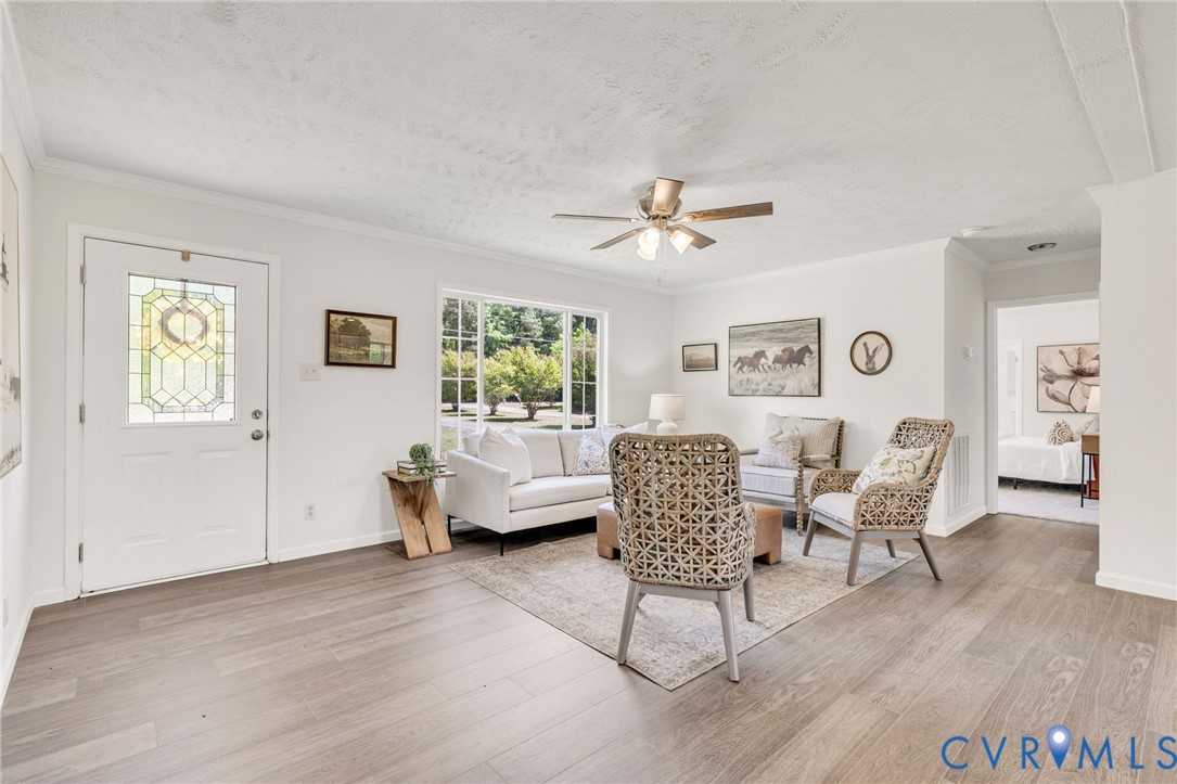 9424 Marlfield Road Gloucester, VA 23061 - Photo 6 of 31 a living room with furniture and a wooden floor