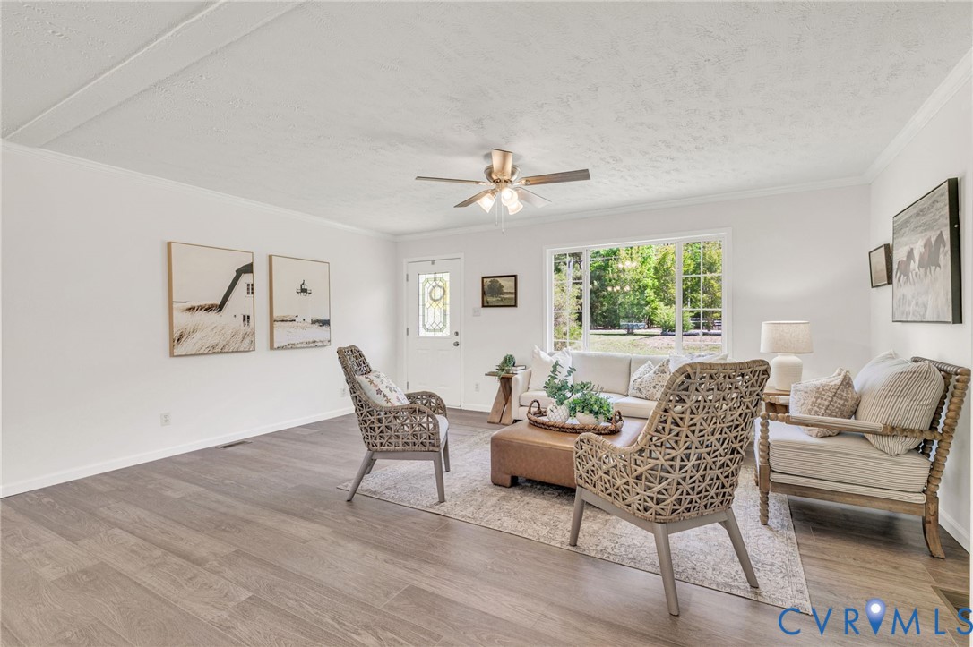 9424 Marlfield Road Gloucester, VA 23061 - Photo 7 of 31 a dining room with furniture a chandelier and wooden floor