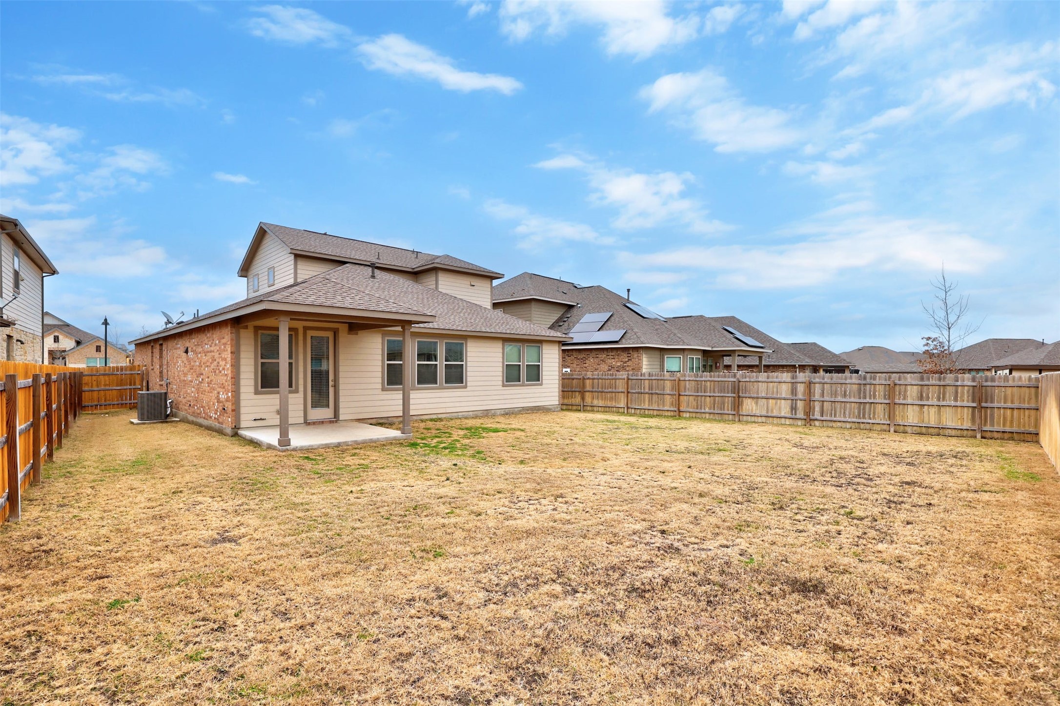 307 Simmental Loop Hutto, TX 78634 - Photo 31 of 34 A spacious backyard with a private fence, offering a welcoming outdoor living area.
