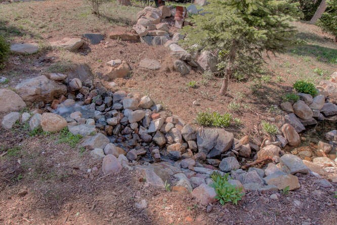 273 Bullion Mine Road Keystone, CO 80435 - Photo 14 of 34 Seasonal water feature includes bubbling springs tumbling through rock-lined base around patio