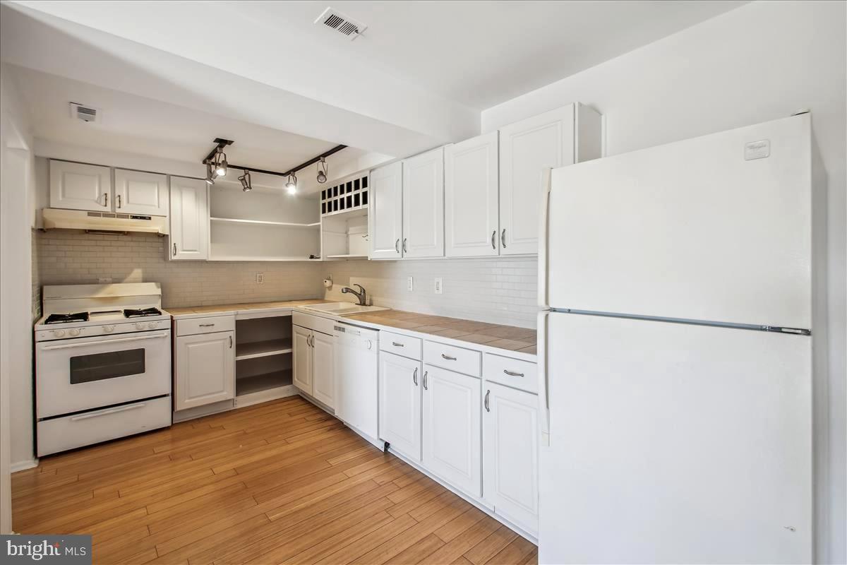 2574 Riva Road, Unit 12A Annapolis, MD 21401 - Photo 12 of 33 a kitchen with a white cabinets and white appliances