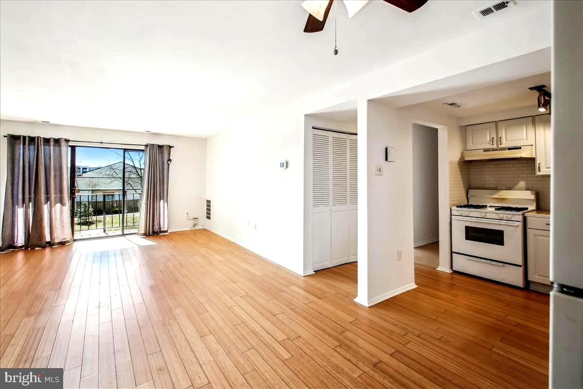 2574 Riva Road, Unit 12A Annapolis, MD 21401 - Photo 2 of 33 a view of a kitchen with an empty room and wooden floor
