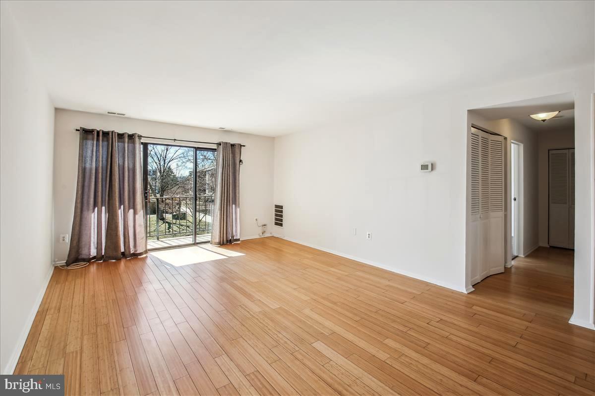 2574 Riva Road, Unit 12A Annapolis, MD 21401 - Photo 7 of 33 a view of an empty room with wooden floor and a window