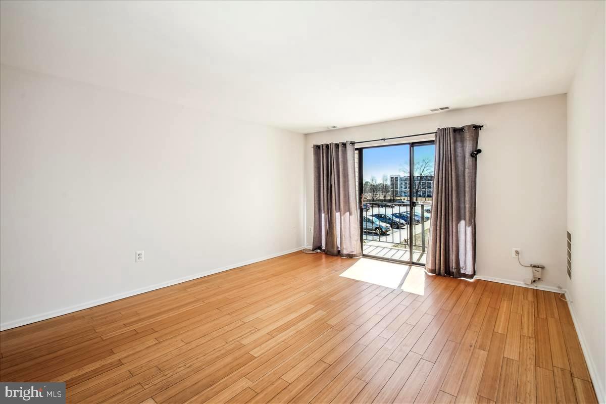 2574 Riva Road, Unit 12A Annapolis, MD 21401 - Photo 8 of 33 a view of an empty room with wooden floor and a window