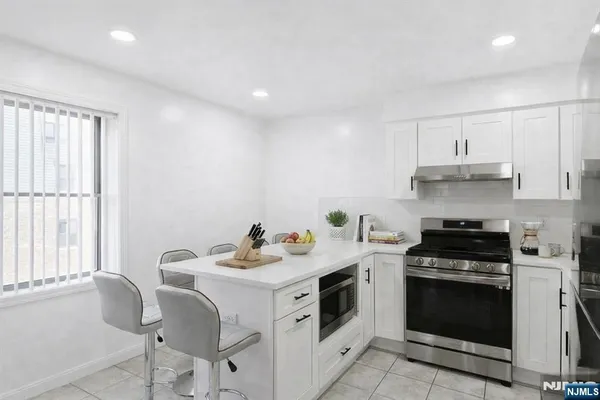 a kitchen with a stove a sink and a microwave