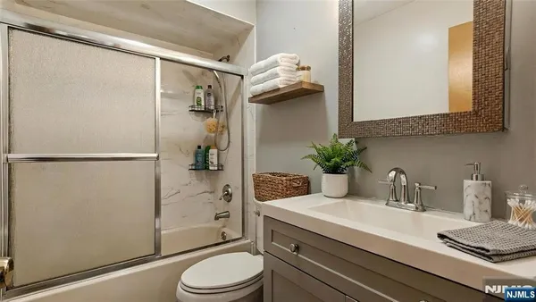 a bathroom with a bath tub with a shower