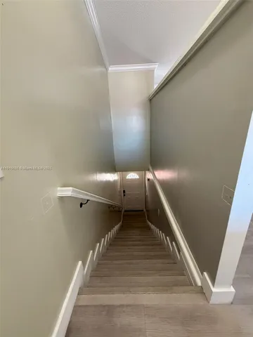 a view of a hallway with stairs