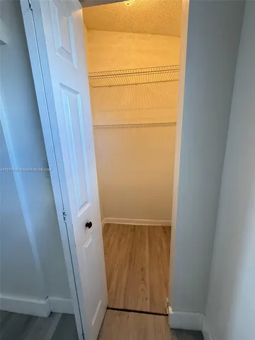 an entryway door with wooden floor