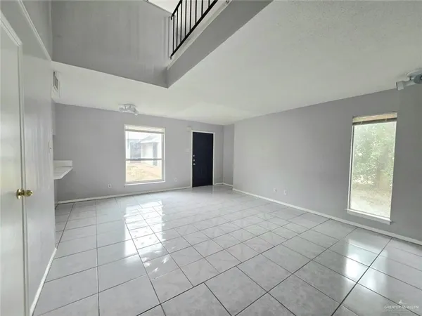 a view of empty room with windows and entryway