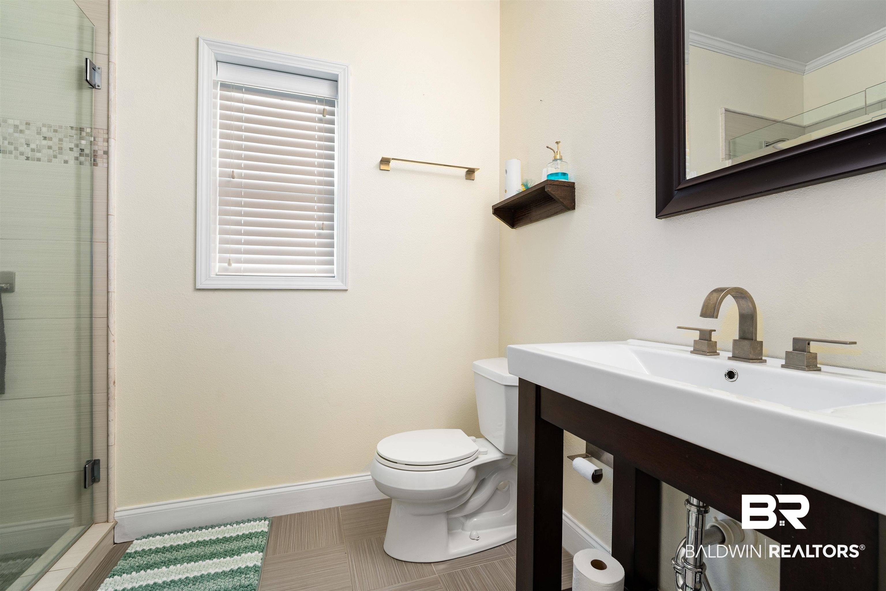 25806 Pollard Road, Unit 205 Daphne, AL 36526 - Photo 17 of 26 Bathroom featuring a stall shower and crown molding