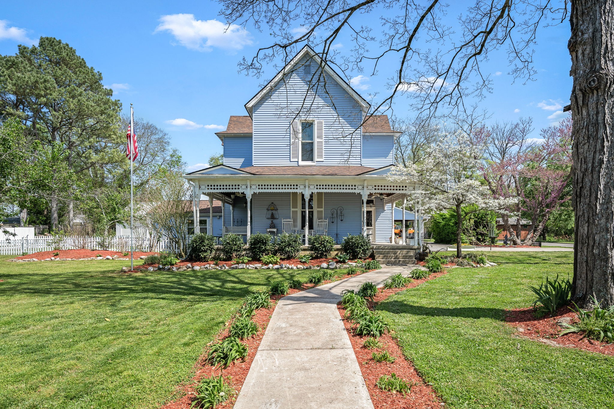 a front view of a house with a yard table and chairs
