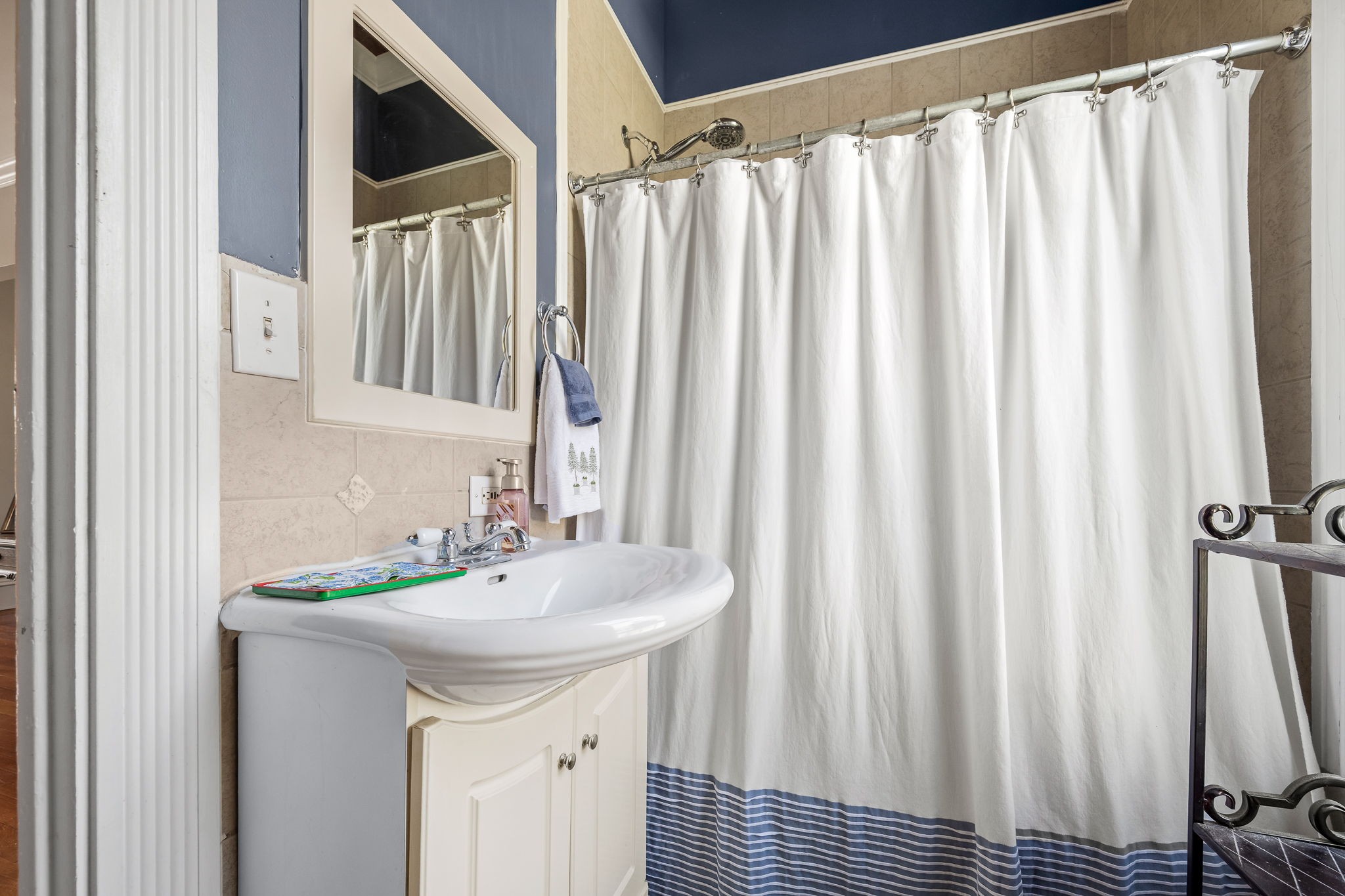 202 High Street Bell Buckle, TN 37020 - Photo 34 of 93 a bathroom with a sink a mirror and a shower curtain