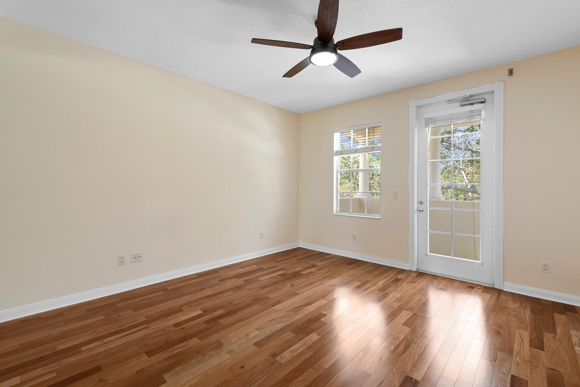 1836 Jeaga Drive Jupiter, FL 33458 - Photo 11 of 25 a view of empty room with wooden floor and fan