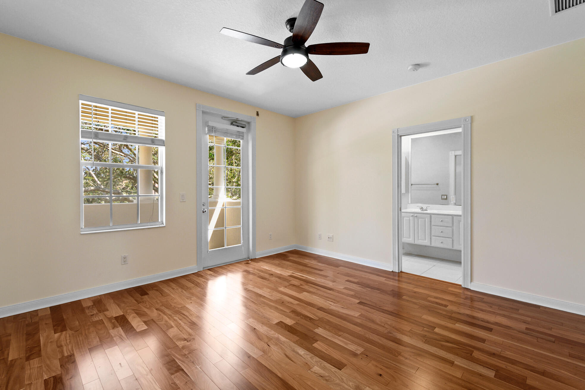 1836 Jeaga Drive Jupiter, FL 33458 - Photo 12 of 25 a view of an empty room with window and wooden floor