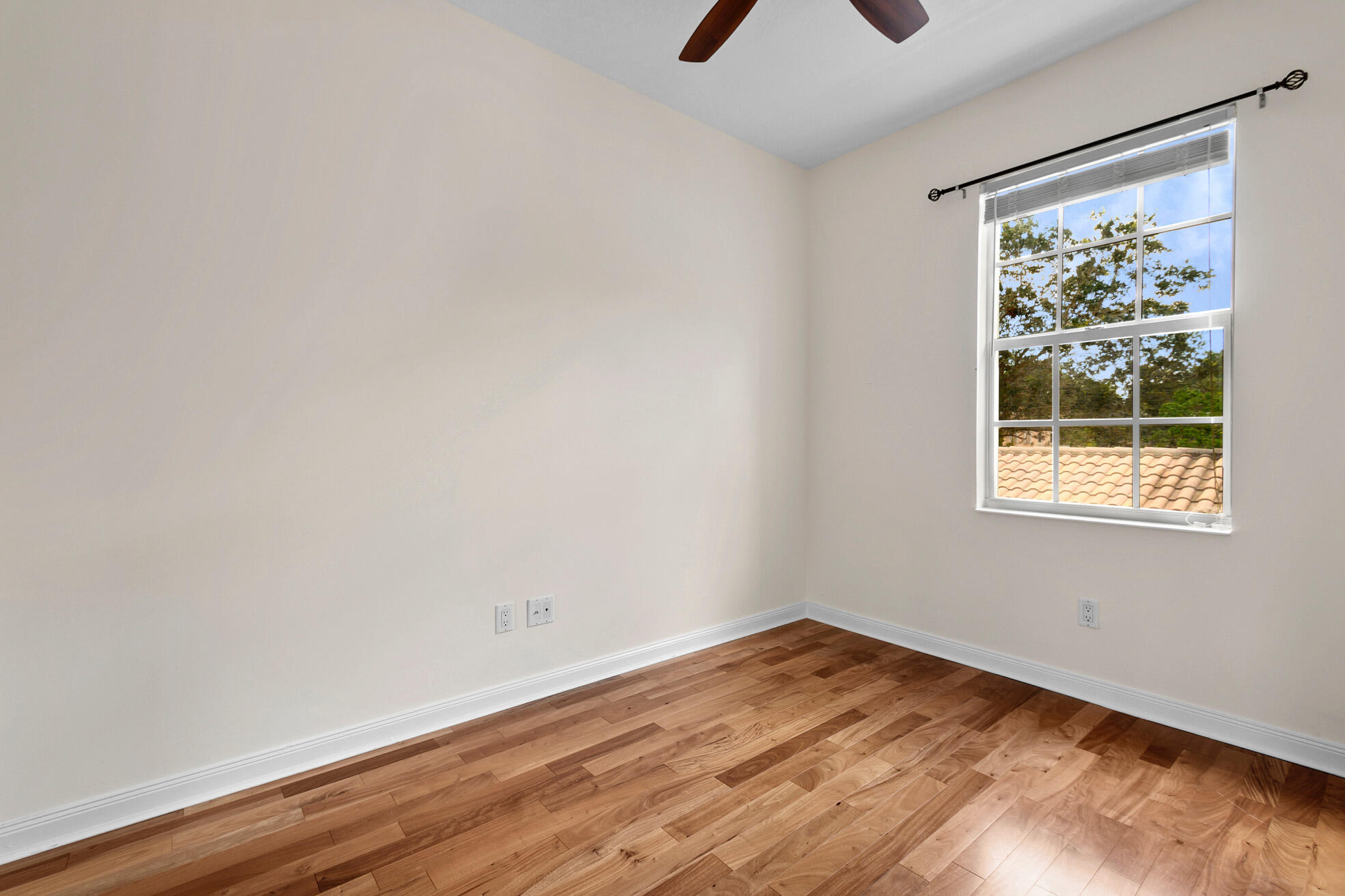 1836 Jeaga Drive Jupiter, FL 33458 - Photo 15 of 25 an empty room with wooden floor and windows