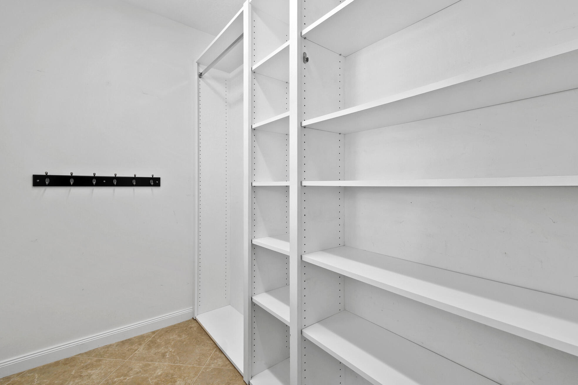 1836 Jeaga Drive Jupiter, FL 33458 - Photo 19 of 25 a view of walk in closet with empty racks