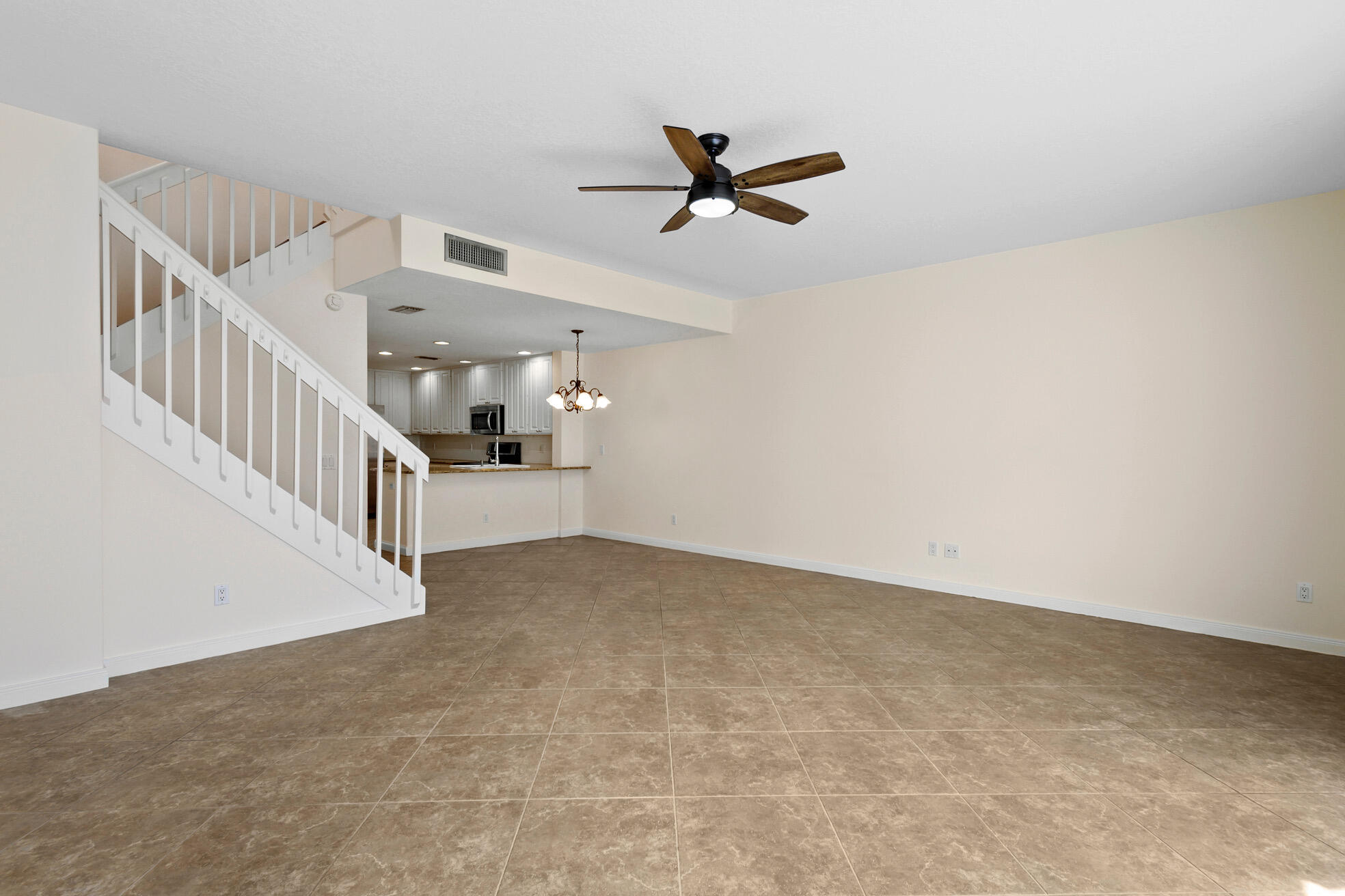 1836 Jeaga Drive Jupiter, FL 33458 - Photo 4 of 25 a view of a livingroom with a ceiling fan
