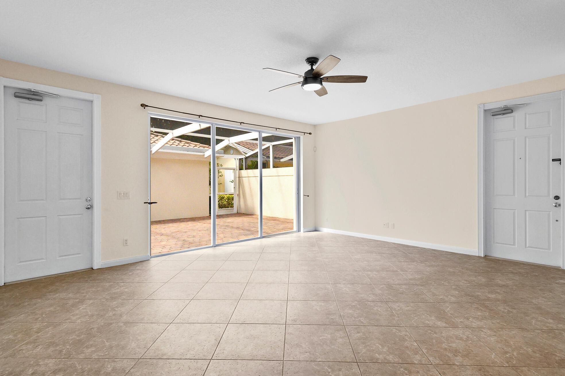 1836 Jeaga Drive Jupiter, FL 33458 - Photo 6 of 25 a view of a livingroom with a chandelier fan and windows