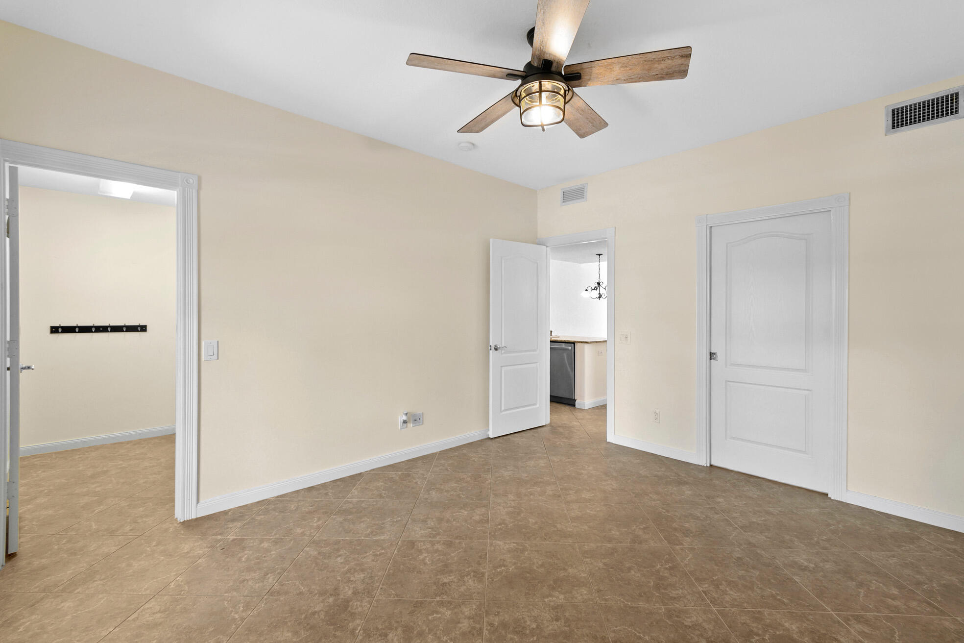 1836 Jeaga Drive Jupiter, FL 33458 - Photo 9 of 25 wooden floor in an empty room and a ceiling fan