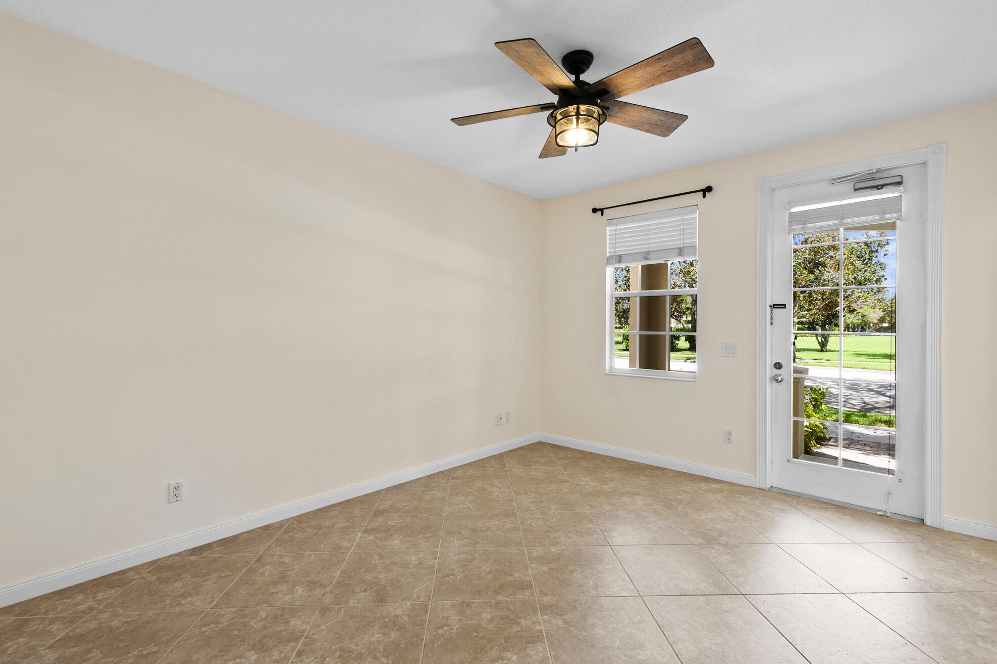1836 Jeaga Drive Jupiter, FL 33458 - Photo 10 of 25 an empty room with windows and ceiling fan