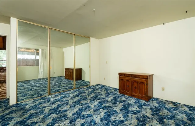 a view of backyard with wooden fence