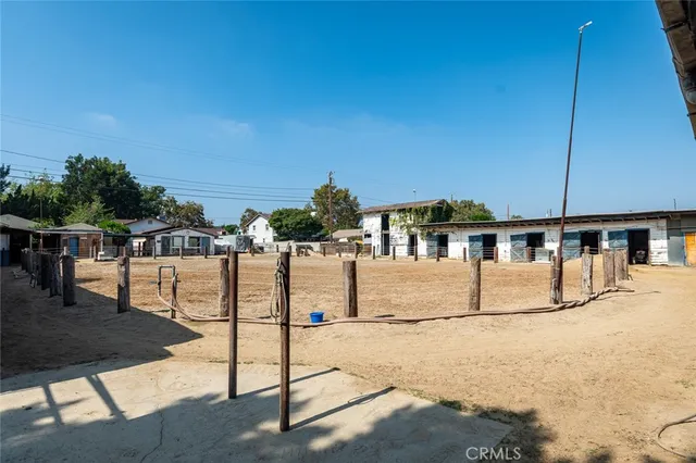 an aerial view of residential house with outdoor space and trees all around