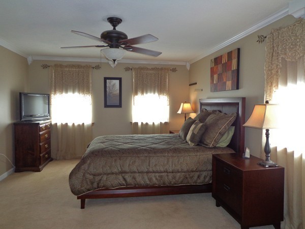 22 Pheasant Drive Springfield, MA 01119 - Photo 17 of 28 a bedroom with a bed and a tv on the dresser