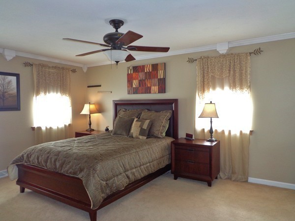 22 Pheasant Drive Springfield, MA 01119 - Photo 8 of 28 a bedroom with a bed chandelier and a window