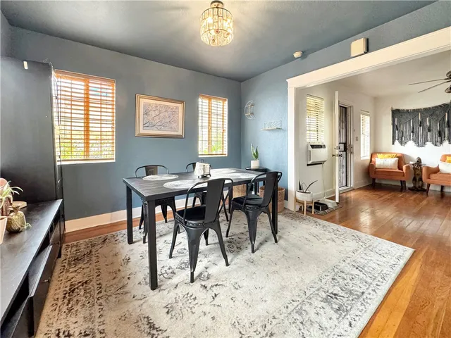 a view of a a dining room with furniture window and wooden floor