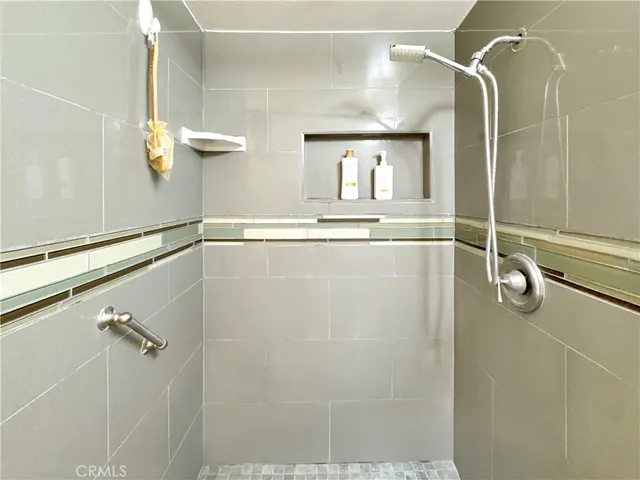 a bathroom with a mirror and shower