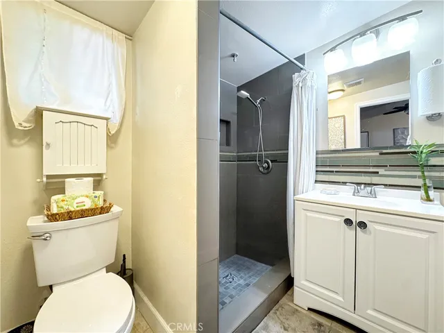 a bathroom with a toilet a sink and a mirror