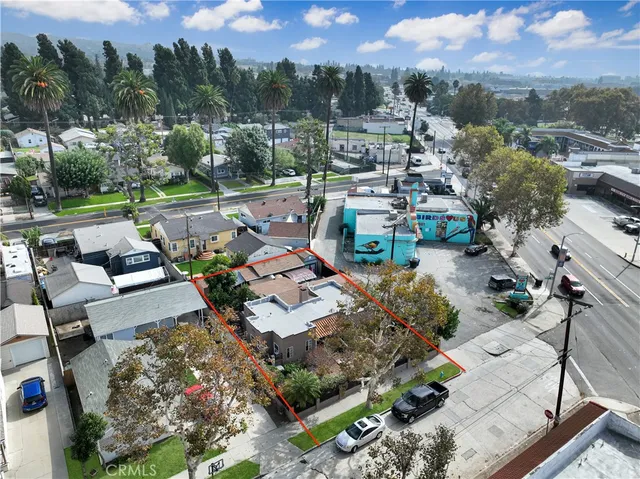 an aerial view of a house with a garden and lake view