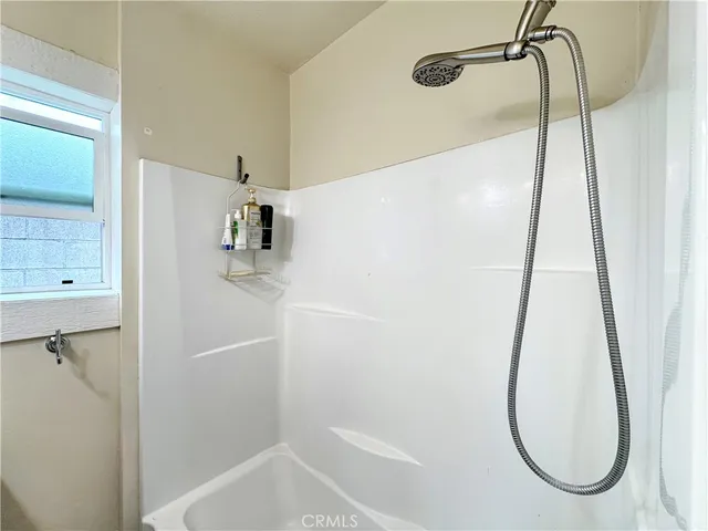 a bathroom with a bath tub and a shower