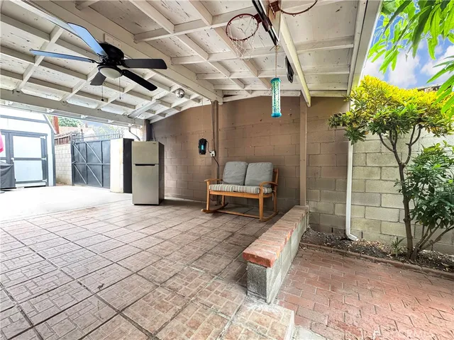 a view of a patio with table and chairs and potted plants