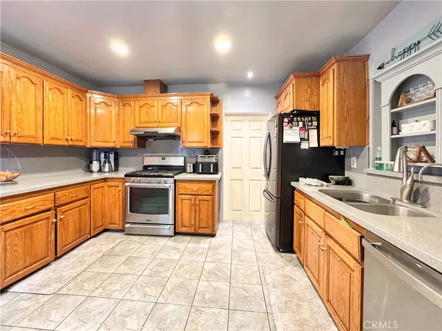 a kitchen with a sink window and cabinets