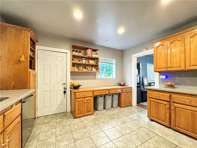 a large kitchen with stainless steel appliances granite countertop a sink and cabinets