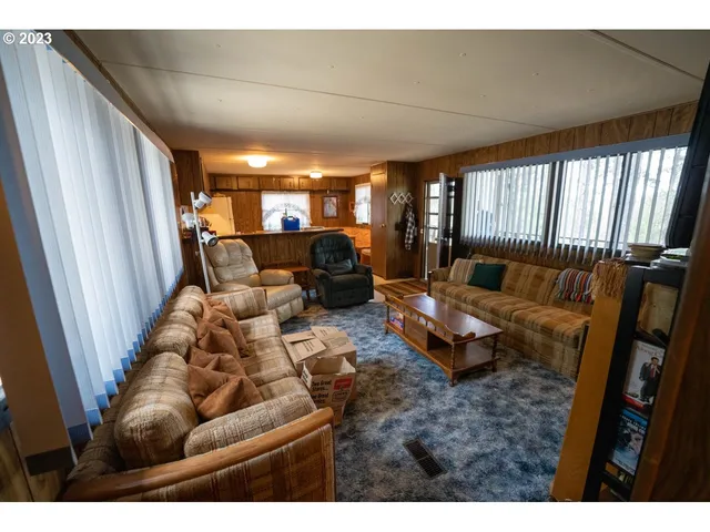 a kitchen with kitchen island a stove top oven a sink a dining table and chairs