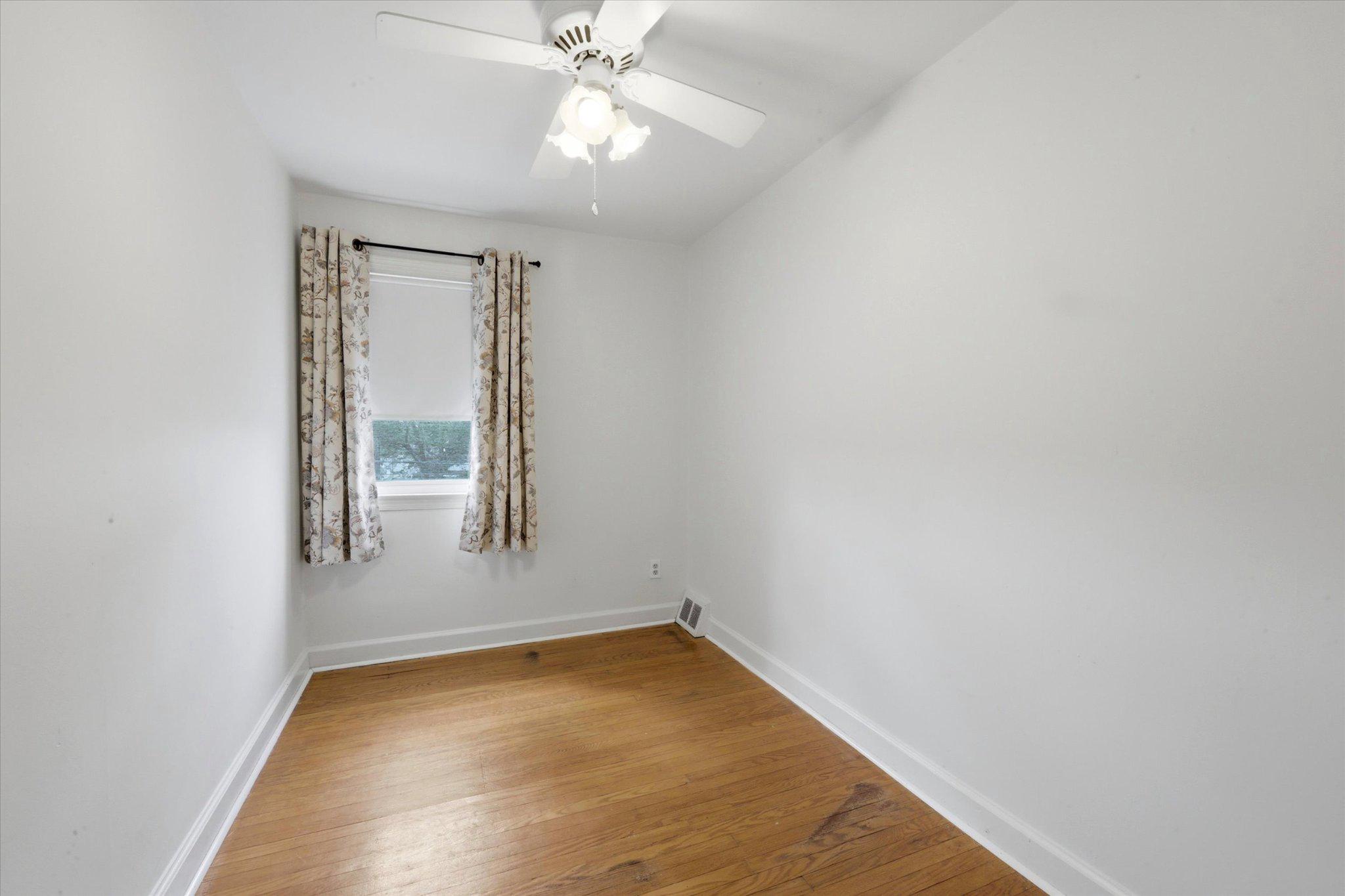 615 Michell Street Ridley Park, PA 19078 - Photo 14 of 25 an empty room with a chandelier fan and windows