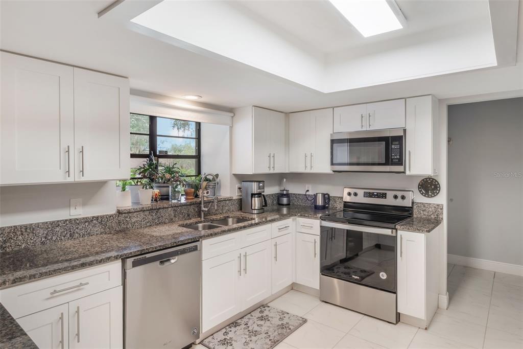 1760 12th Street Clermont, FL 34711 - Photo 12 of 42 a kitchen with white cabinets sink and stainless steel appliances