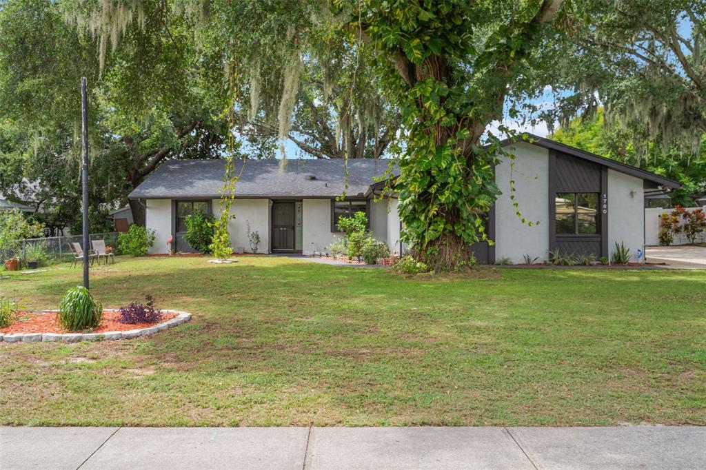 1760 12th Street Clermont, FL 34711 - Photo 2 of 42 a front view of a house with garden