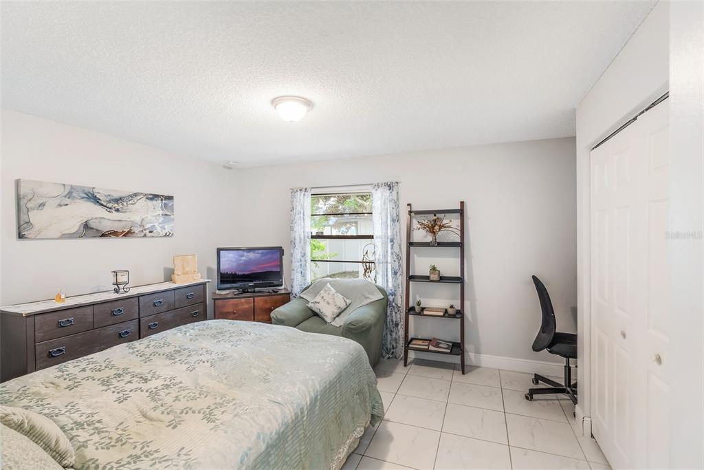 1760 12th Street Clermont, FL 34711 - Photo 22 of 42 a bed room with a bed and a chair in it